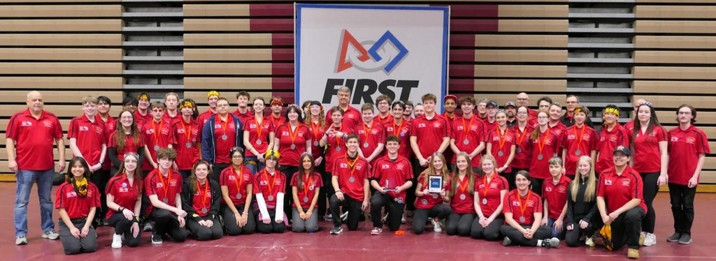 Team photo of HVS robotics team with about two dozen members all wearing red team shirts