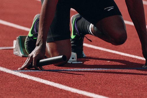 Picture of a runner's legs in blocks getting ready to start
