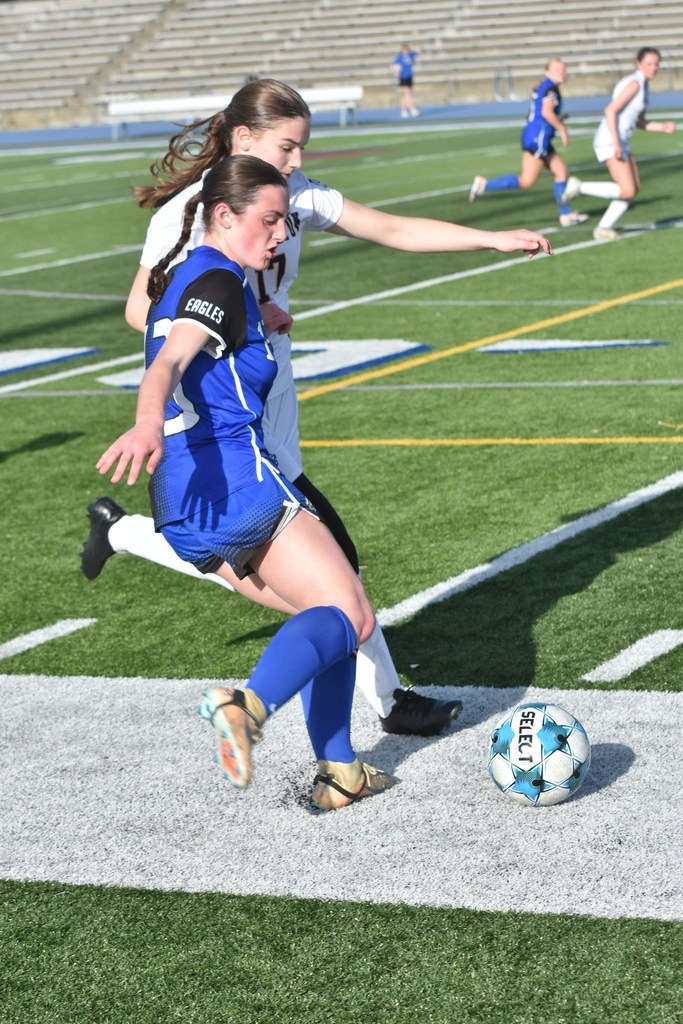 Lakeland soccer player battling a defender for the ball