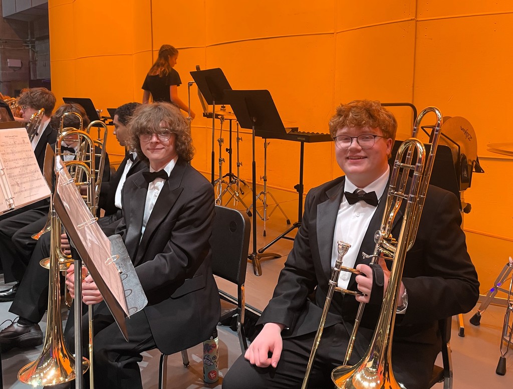 Two members of the HV Wind Ensemble on stage with their instruments