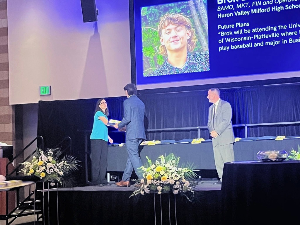 Student receiving award walking across the stage