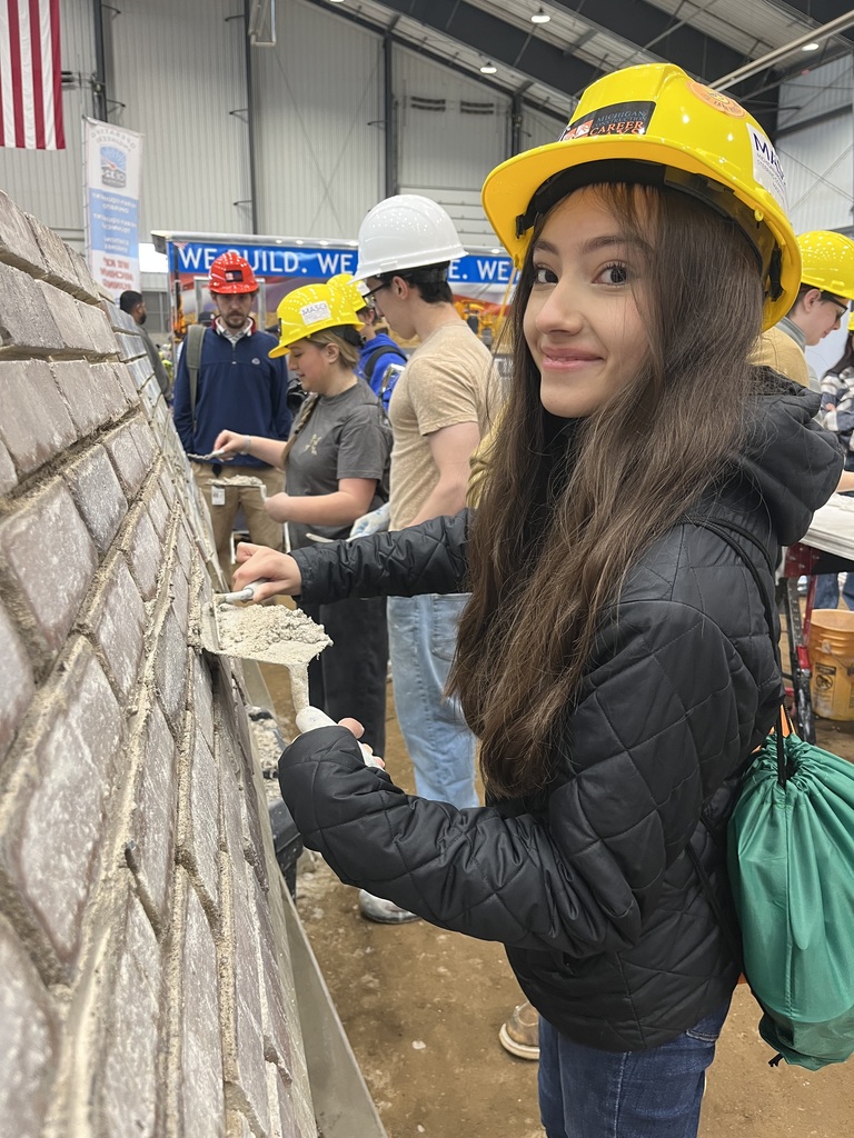 A student laying brick