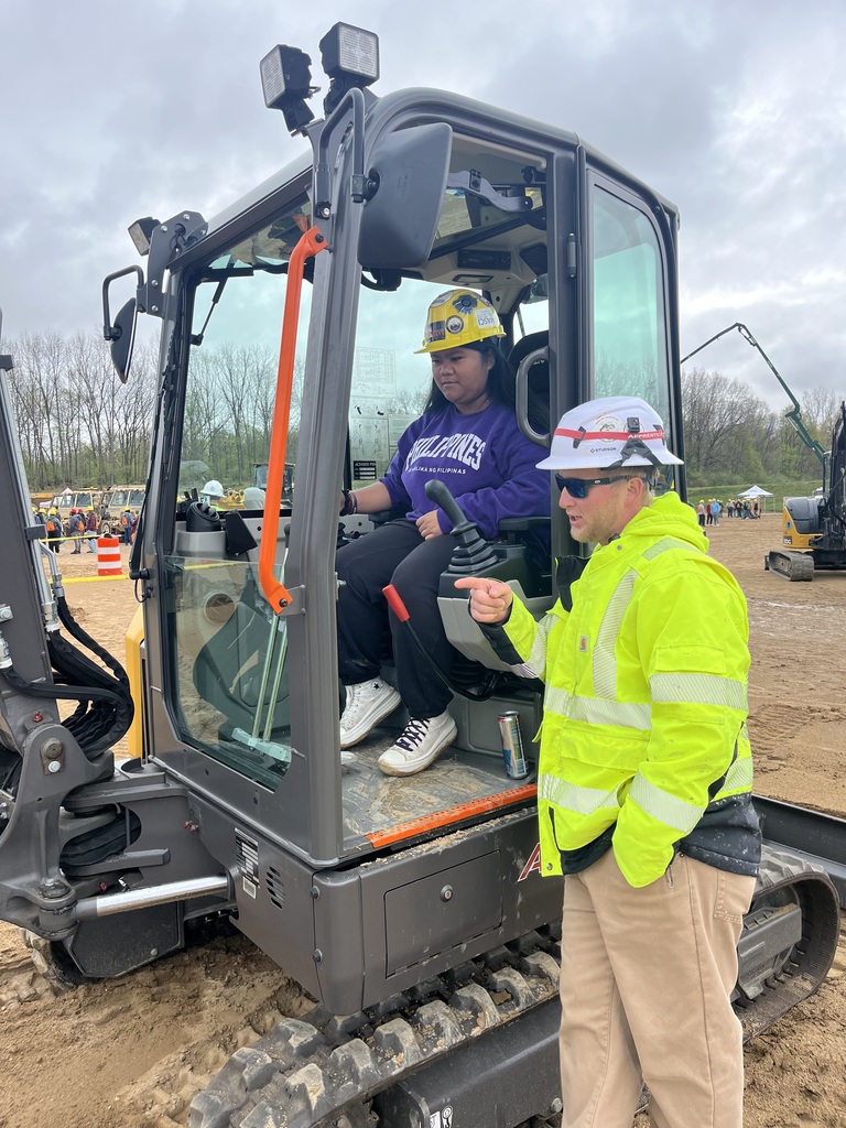 Student operating a backhoe