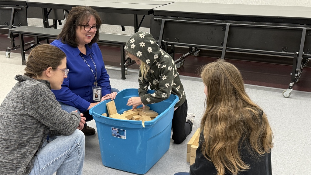 Teacher playing with kids at school age care