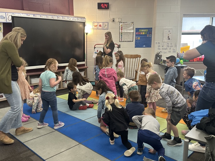 k day students moving around in classroom