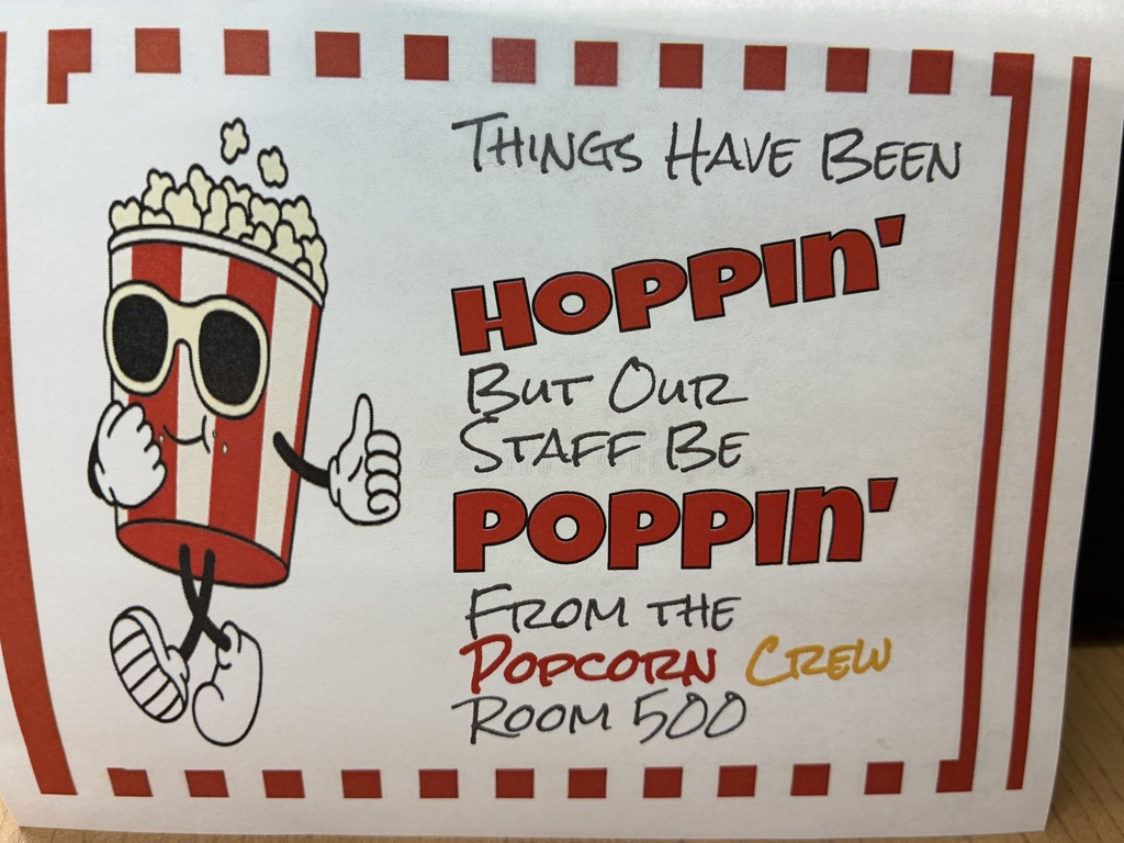 Gfx with popcorn bucket walking that reads.. things have been hoppin, but our staff be poppin'.. from the popcorn crew room 500"