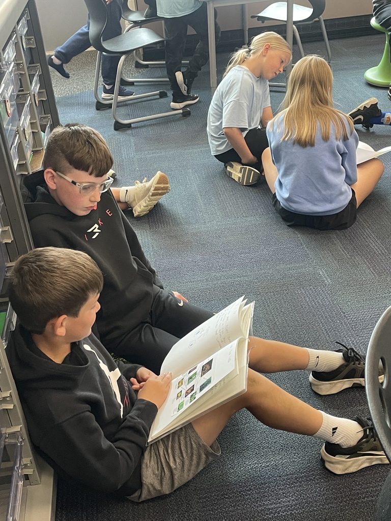 5th graders reading with their 4th grade buddies