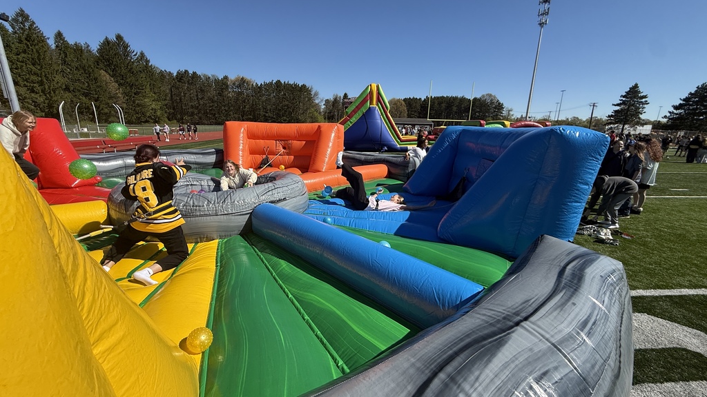 Photo of students playing a game in an inflatable on football field at MHS
