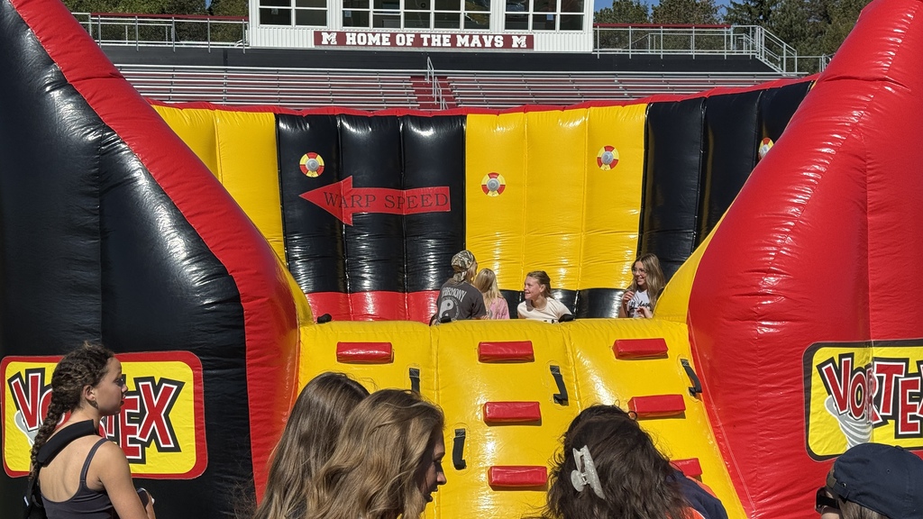 Photo of students playing a game in an inflatable on football field at MHS
