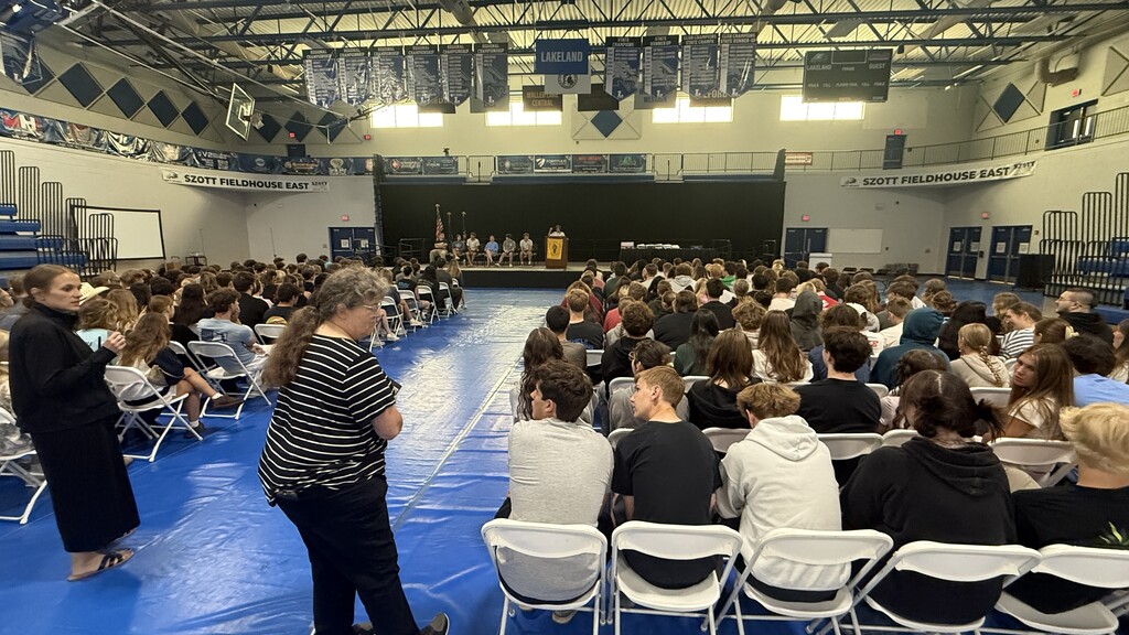 SHOT OF SEVERAL STUDENTS SITTING DURING A GRADUATION REHEARSAL
