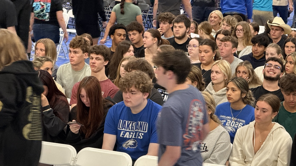 SHOT OF SEVERAL STUDENTS SITTING DURING A GRADUATION REHEARSAL