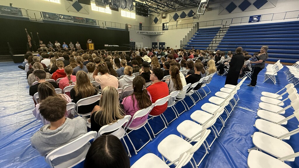 SHOT OF SEVERAL STUDENTS SITTING DURING A GRADUATION REHEARSAL