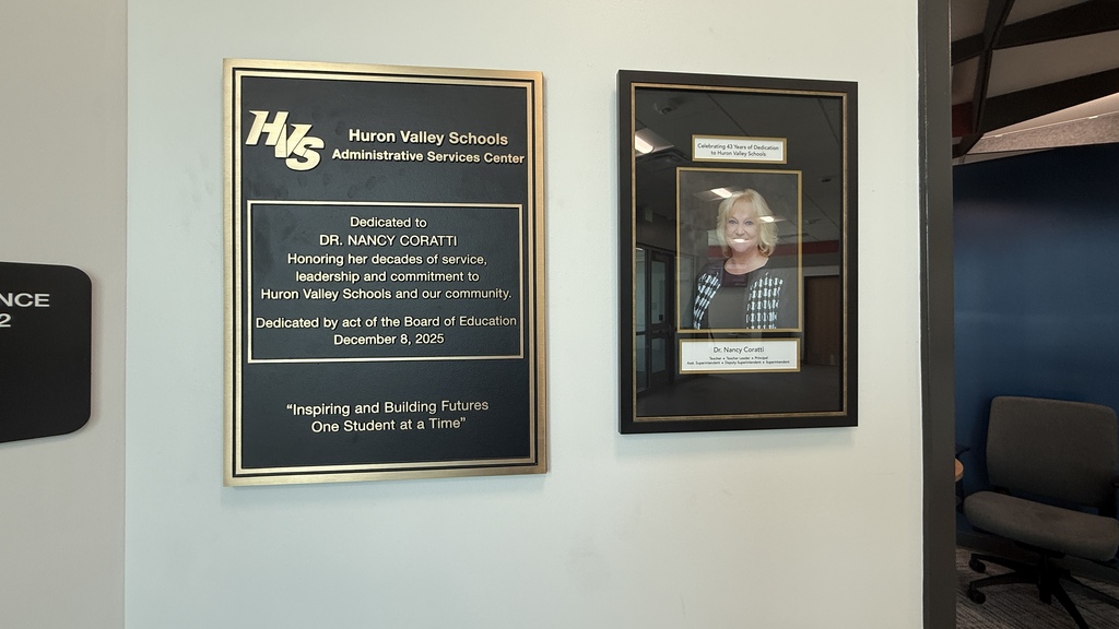 photo of plaques on a wall honoring Nancy Coratti one with her photo