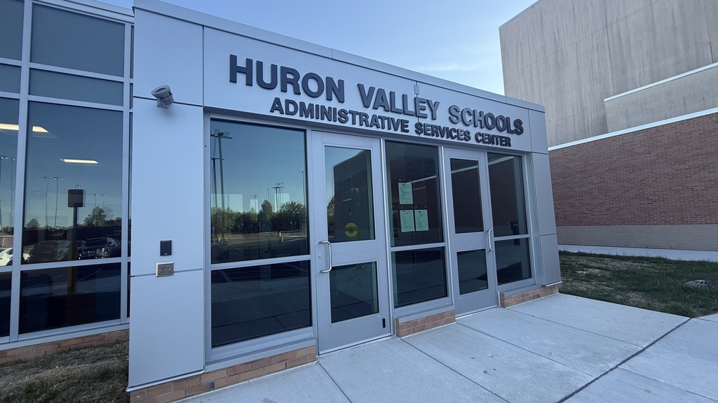 Photo of the front of the new admin services center with a sign over the doors 