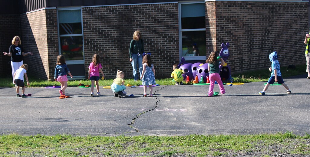Photo of kids running and playing on field day outside their center