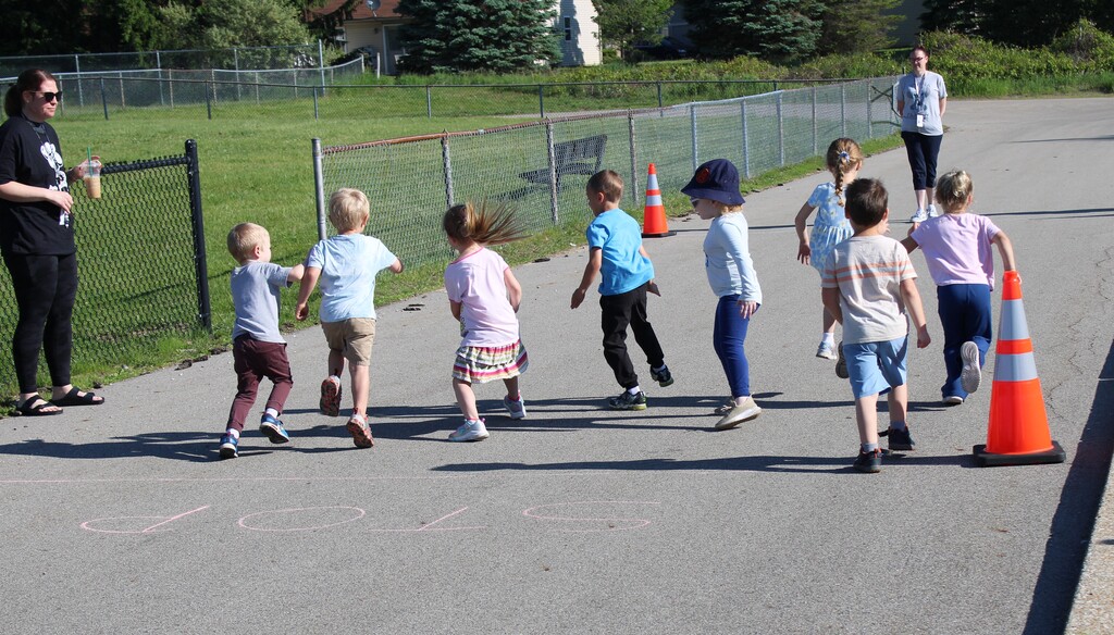 Photo of kids running and playing on field day outside their center