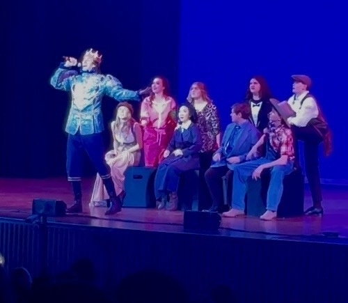 several thespians performing on stage 