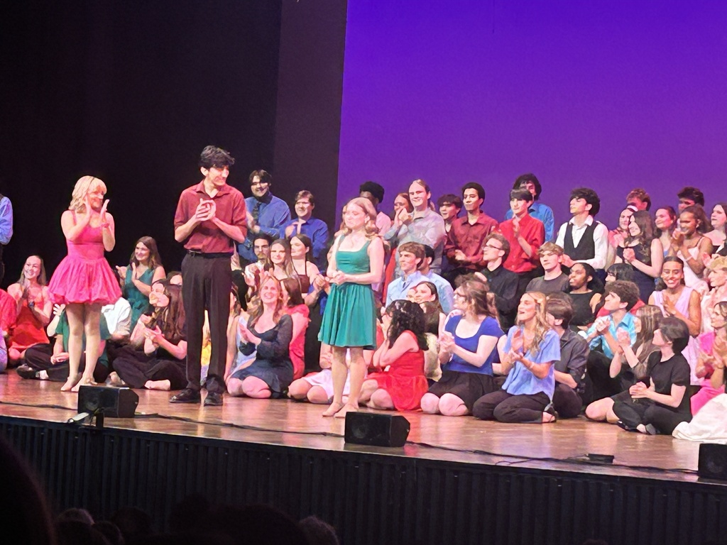 several thespians performing on stage 