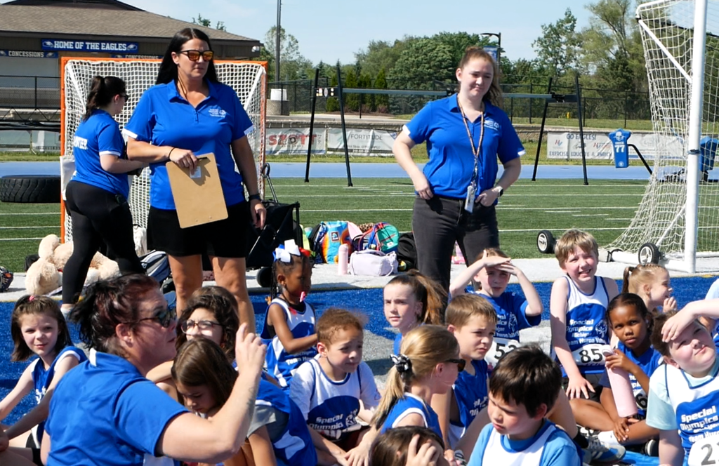Photo of kids and instructors huddled up during unified sports event