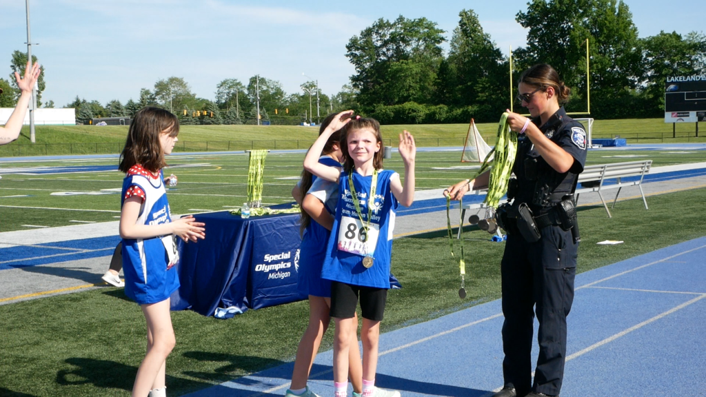 Photo of athlete getting medal at unified sports event on track