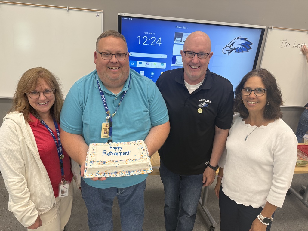 Four people holding a retirement cake
