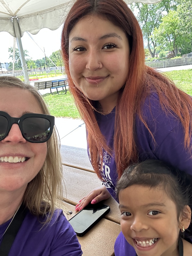 Two women and a child smiling and posing for a photo