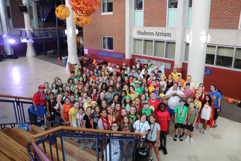 Large group photo of students gathered at the bottom of a flight of stairs
