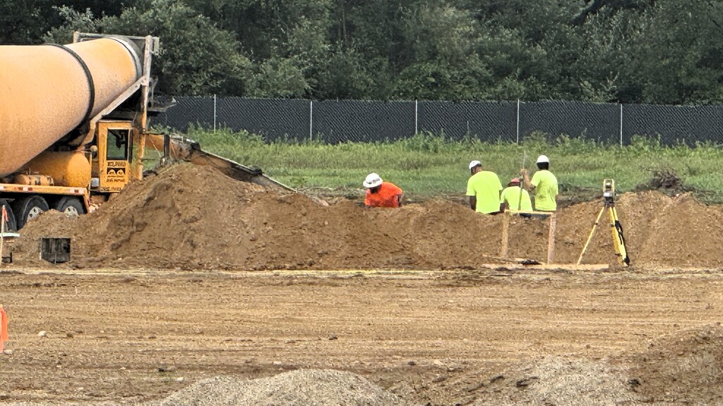 photo of construction workers digging on a work site