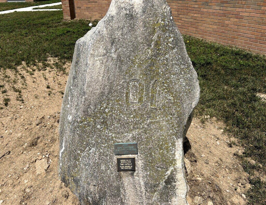Photo of large rock with metal plaque attached