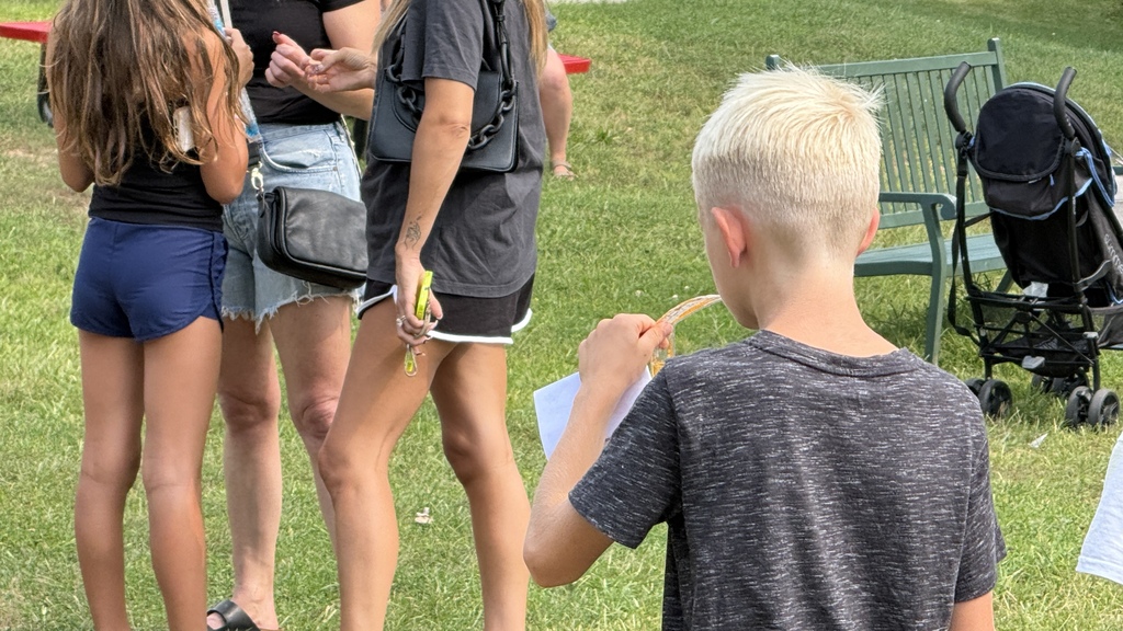 boy eating a popsicle outside