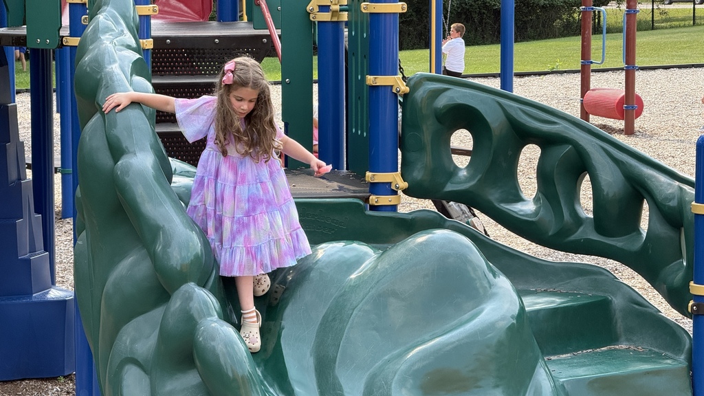 girl playing on playground equipment