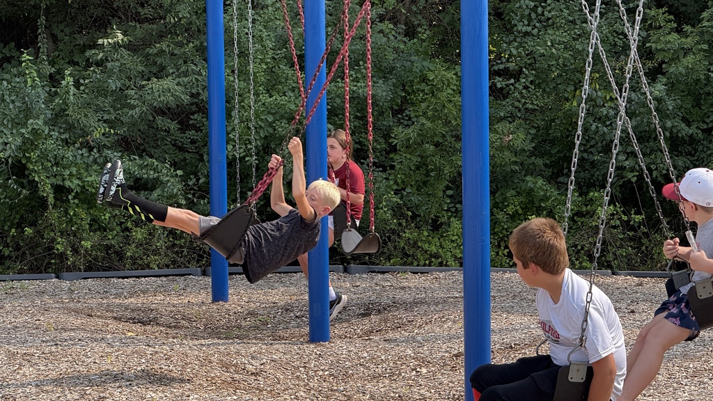 boys swinging on swings outside