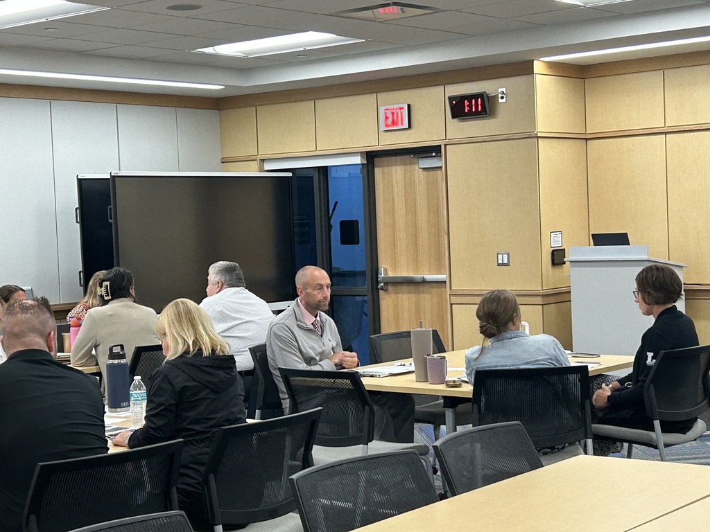HVS administrators sitting at a table discussing safety protocols