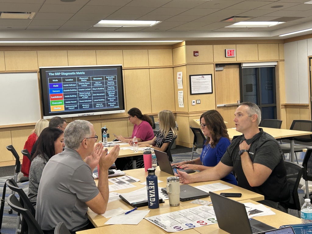 HVS administrators sitting at a table discussing safety protocols