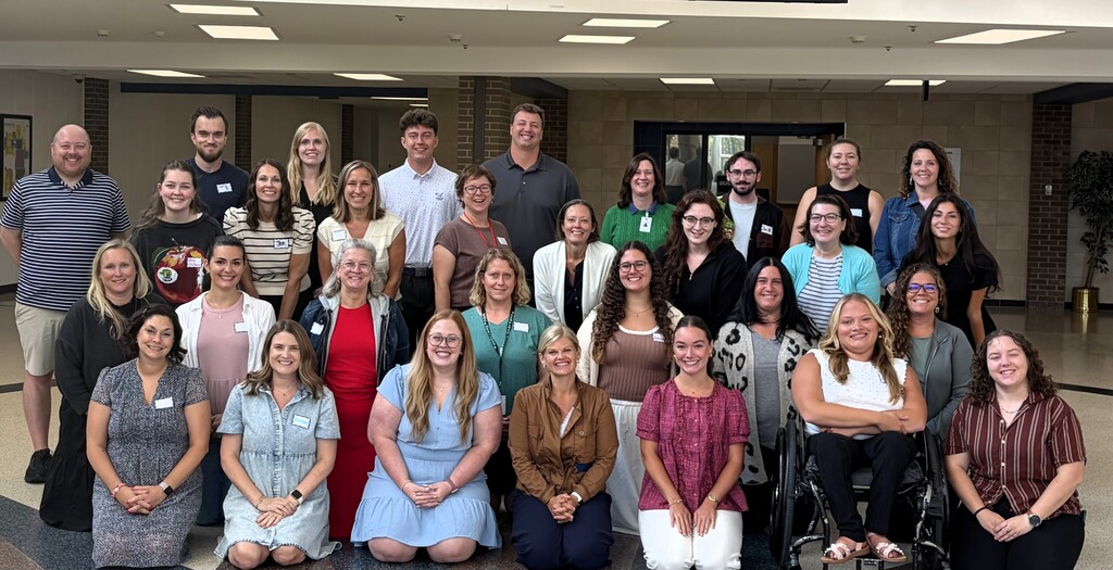 Group photo of 31 new educators, women and men, smiling 