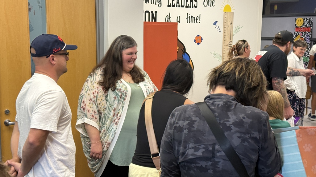 Students and parents tour a school building