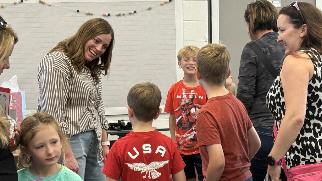Students and parents tour a school building
