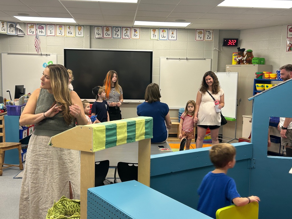 Students and parents tour a school building