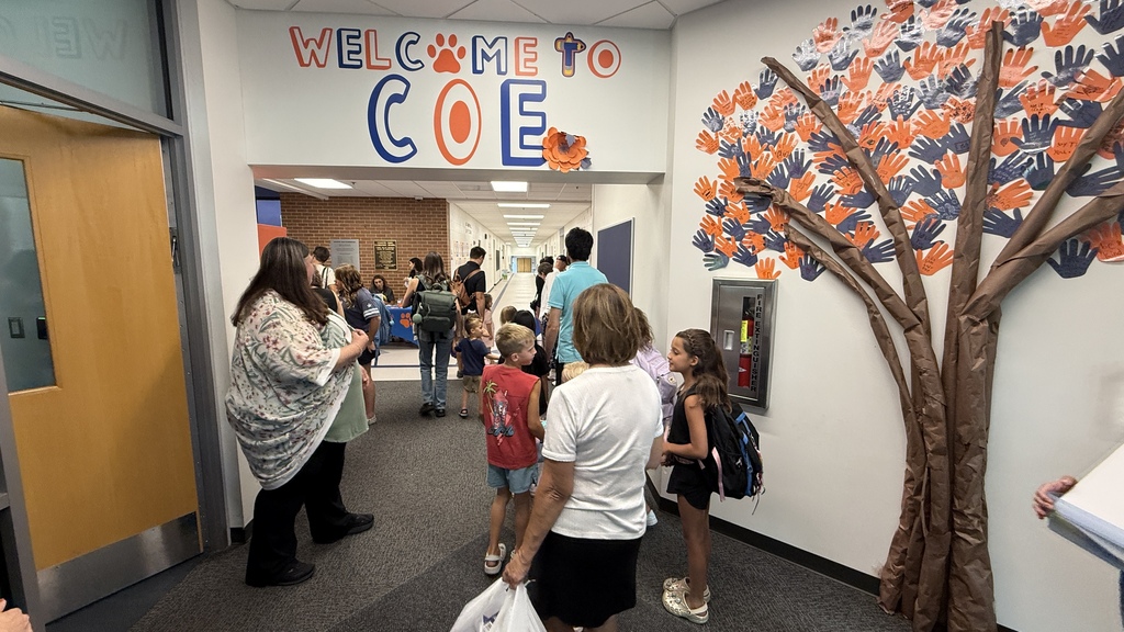 Students and parents tour a school building