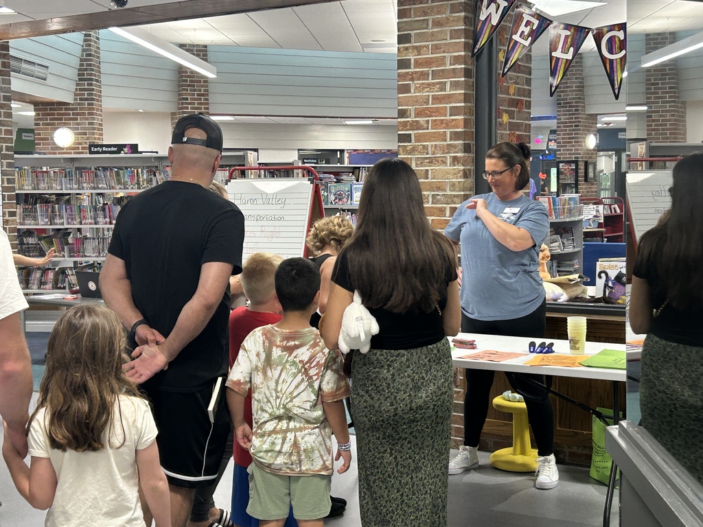 Students and parents tour a school building