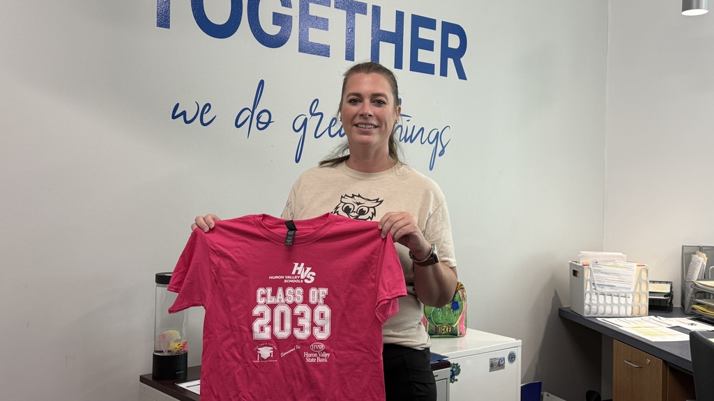Woman holding hot pink tshirt that reads "class of 2039"