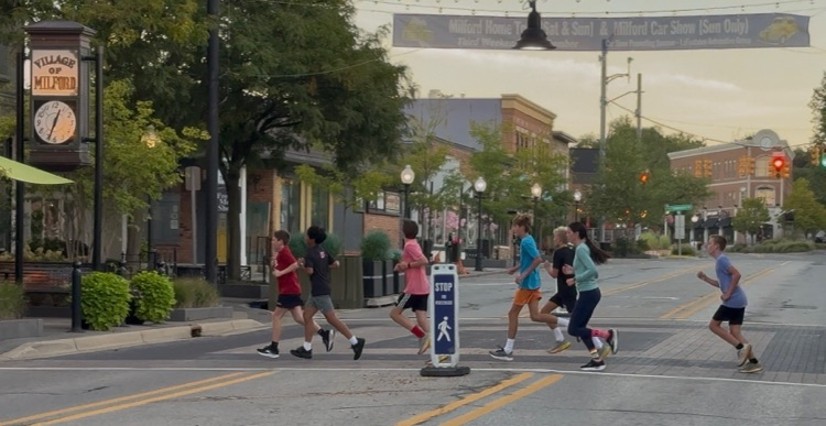 Students running through downtown Milford
