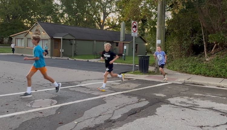 Students running through downtown Milford