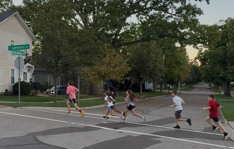 Students running through downtown Milford