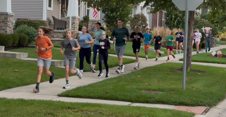 students running through downtown Milford