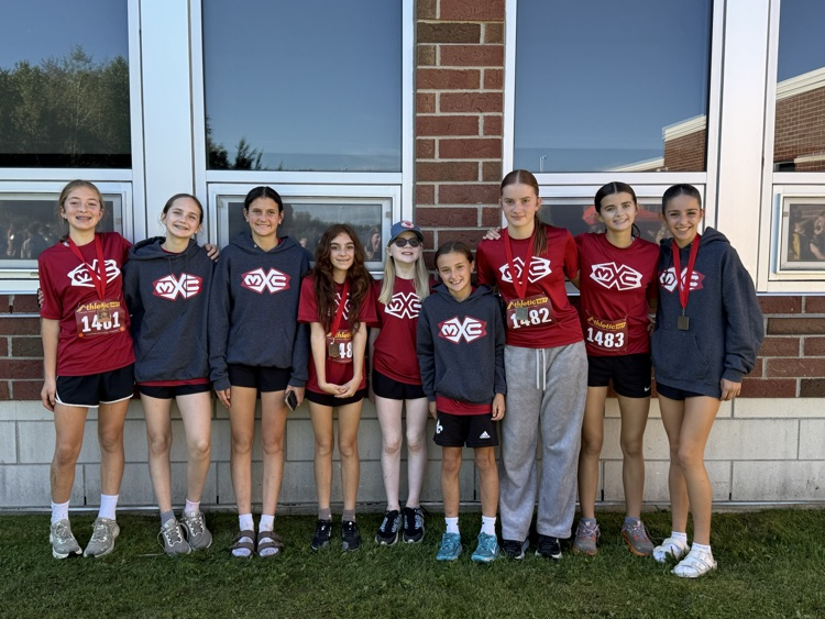 group of student runners stand together after their race