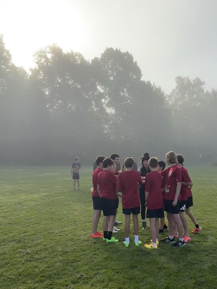 group of runners huddle up before their race