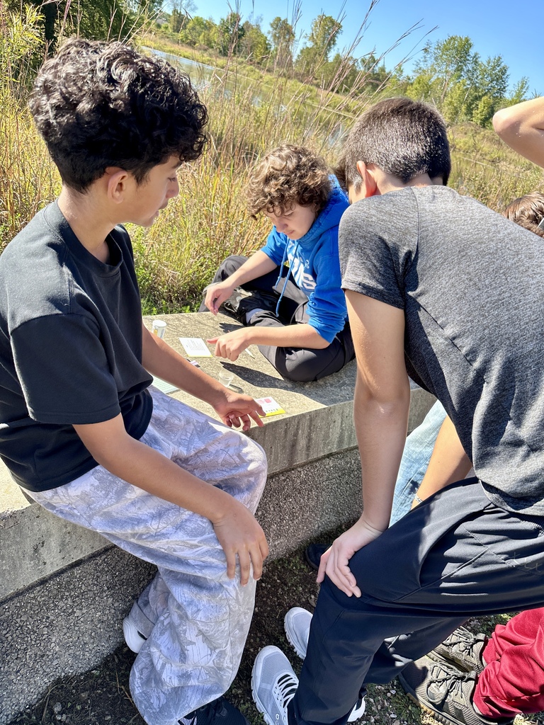 three students gather to test water