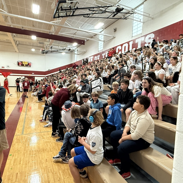 student s sitting on bleachers in a gym