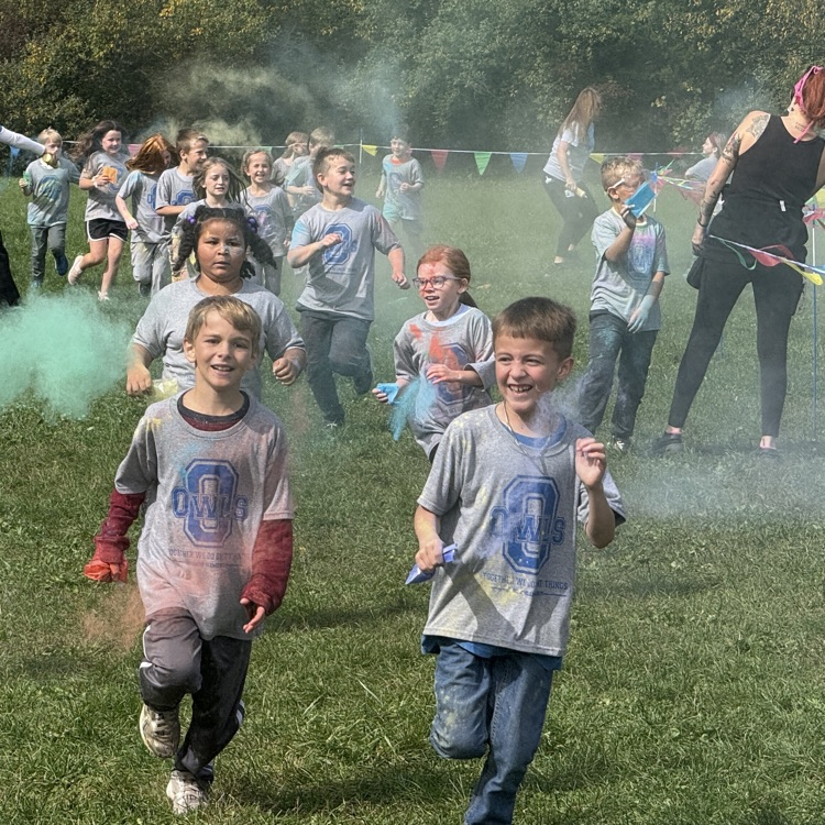 students run with color powder all over them